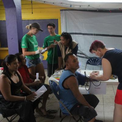 Volunteers helping to check the blood of locals in Belize Projects Abroad volunteers checking blood as part of her Spring Break Public Health Project in Belize